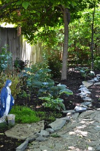 statue at stone patio in grassless Lewiston backyard