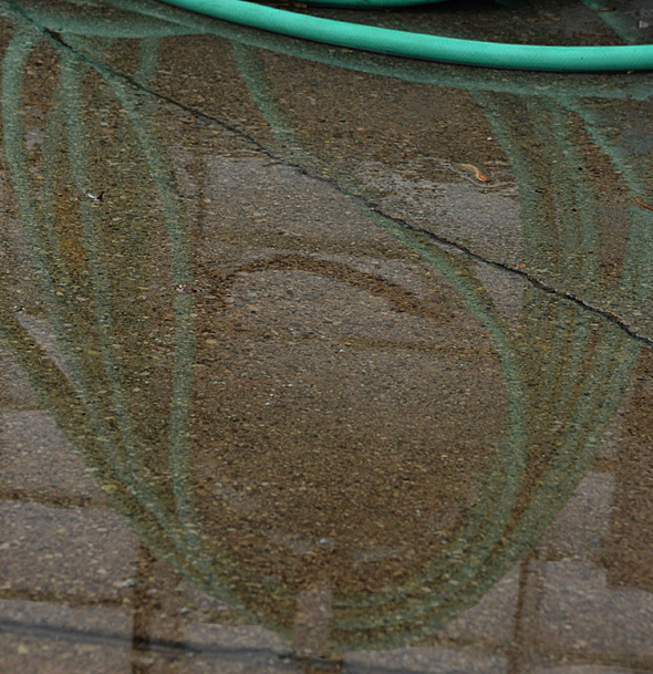 hose reflected in puddle by Stofko