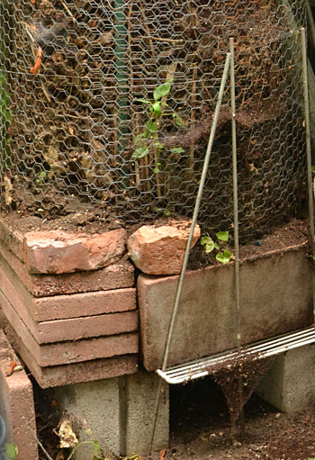 composter made of bricks and chicken wire