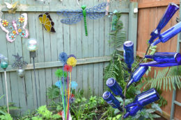blue bottles, painted allium and other garden ornaments