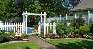 garden beds by fence and pool in Snyder NY