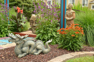 statues of face, dragon and Chinese warrior in Amherst NY garden