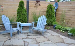 chairs on large stone pavers in grassless backyard in South Buffalo